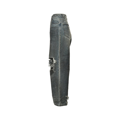 Mud-dyed distressed jeans